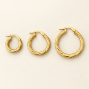 AI-retouched 10K yellow gold textured twisted hoop earrings in three sizes; one pair per selected size