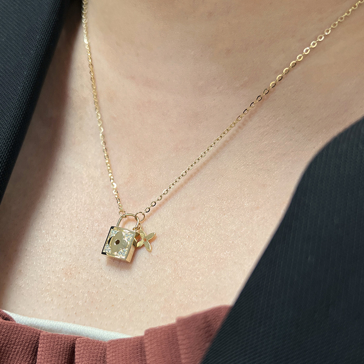 delicate gold 14k diamond lock necklace pendant with small star charm on model
