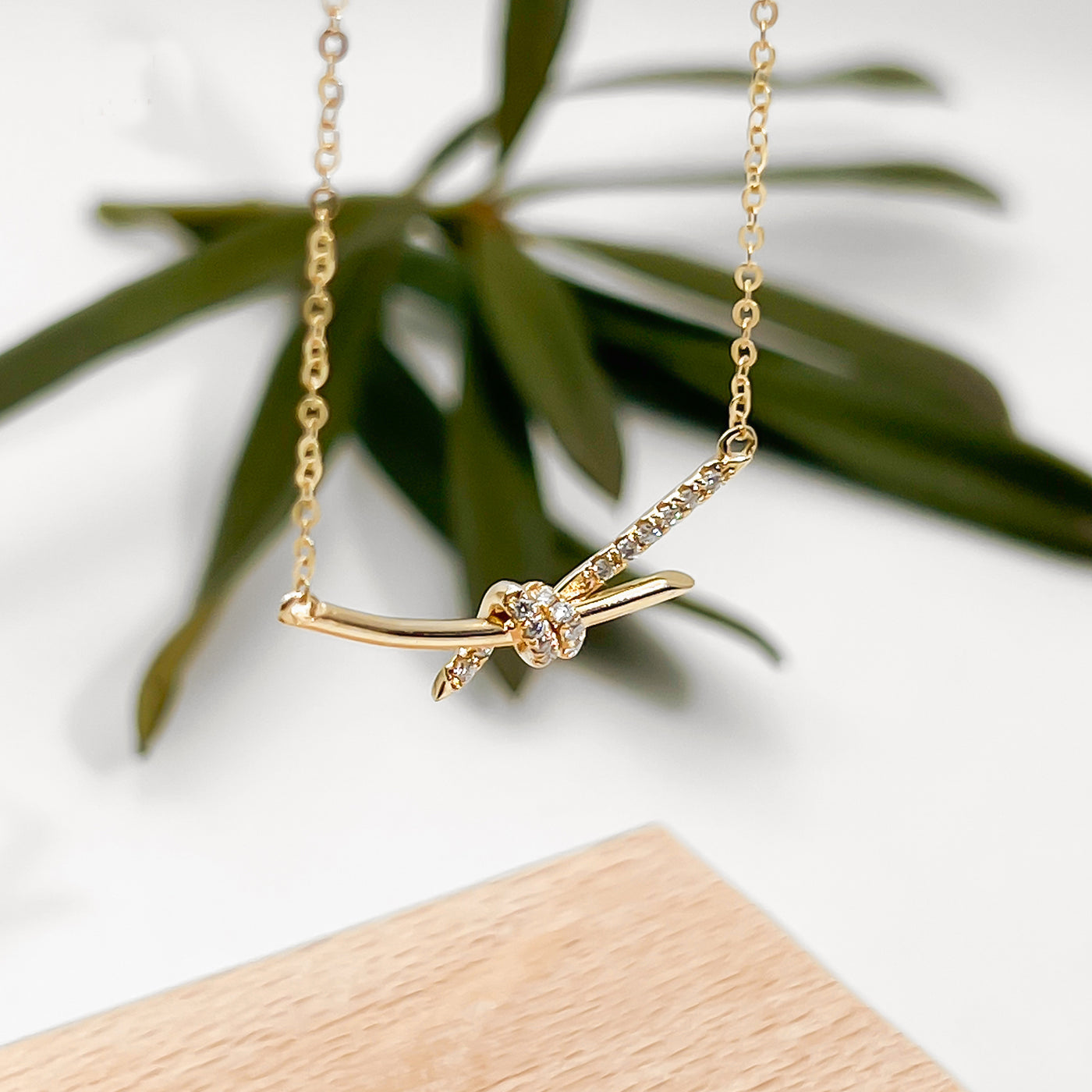 14K gold diamond knot necklace delicate knotted pendant with pave diamonds on fine gold chain ideal for everyday wear