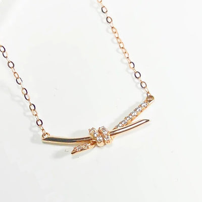 14K gold diamond knot necklace delicate rose gold chain with pave diamond knotted bar pendant