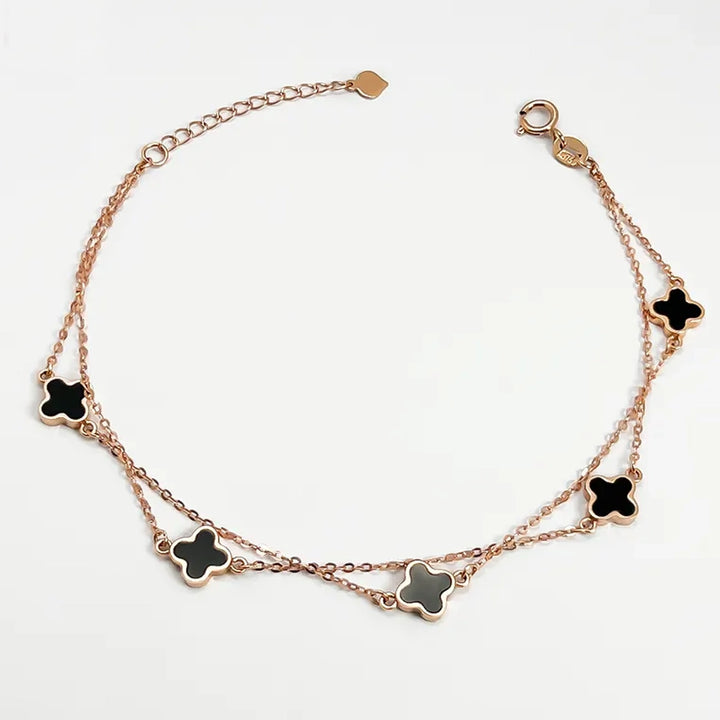 18K clover bracelet rose gold double chain with five black enamel clover charms adjustable lobster clasp