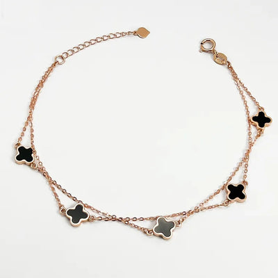 18K clover bracelet rose gold double chain with five black enamel clover charms adjustable lobster clasp